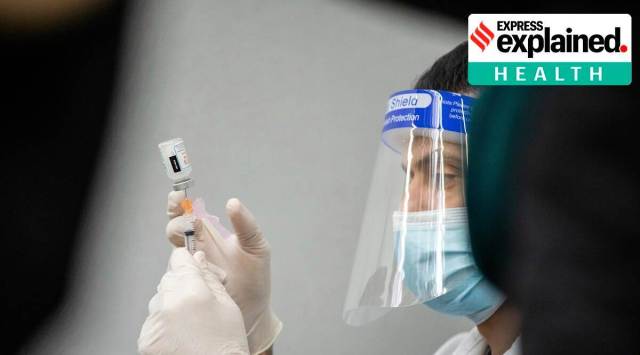 A Walmart employee prepares to administer the Moderna COVID-19 vaccine at a Walmart in the Austin neighborhood, of Chicago. (Pat Nabong/Chicago Sun-Times via AP)