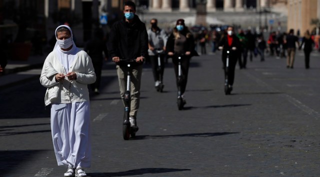 A nun walks in front of St. Peter's Square at the Vatican as Pope Francis celebrates Palm Sunday Mass behind closed doors at the Vatican. (Photo: AP)