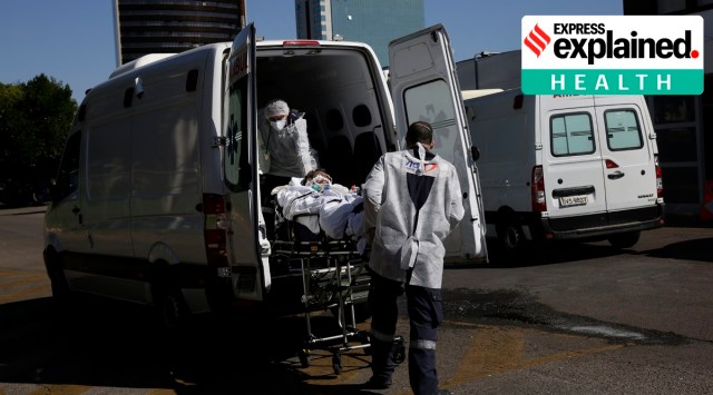 A patient suspected of having COVID-19, is transferred from an ambulance into the HRAN public hospital in Brasilia, Brazil (AP)
