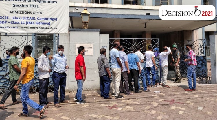 People queue up outside a polling booth in Kolkata on Monday. (Express Photo: Partha Paul)