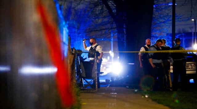 Chicago police work the scene of a shooting early Tuesday, April 6, 2021 in Chicago.   Police say seven people were shot and wounded in a Chicago neighborhood overnight in the city’s latest wave of gun violence. Chicago police say the seven were involved in a fight on the sidewalk when shots were fired late Monday in the Englewood neighborhood on Chicago’s South Side. (Armando L. Sanchez/Chicago Tribune via AP)