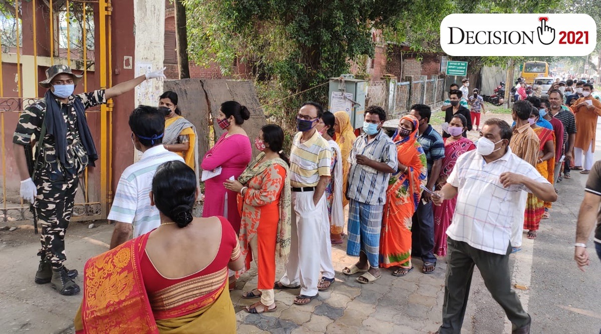 People queue up outside a polling booth in Cooch Behar on Saturday. (Express Photo: Partha Paul)