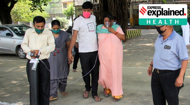 A patients who was in home isolation arrives at a hospital with an oxygen cylinder in Lucknow on Thursday. (Express Photo: Vishal Srivastav)