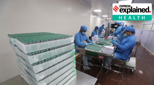 Employees pack boxes containing vials of Covishield at the Serum Institute of India, Pune. (AP/PTI Photo)
