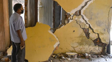 A man looks at the damages caused by the earthquake, in Guwahati on Wednesday. (PTI)