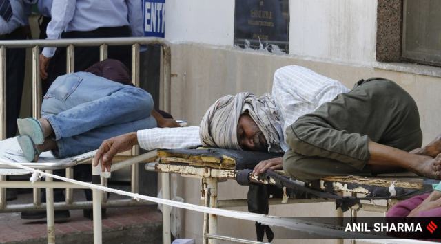 Patients lie on hospital beds outside GTB Hospital in New Delhi on Thursday. (Express Photo: Anil Sharma, File)