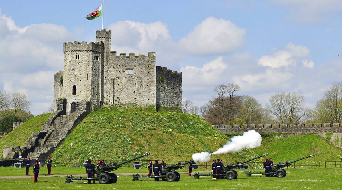 Members of the 104th Regiment Royal Artillery fire a 41-round gun salute in the grounds of Cardiff Castle, to mark the death of Prince Philip, in Cardiff, Saturday, April 10, 2021. Britain's Prince Philip, the irascible and tough-minded husband of Queen Elizabeth II who spent more than seven decades supporting his wife in a role that mostly defined his life, died on Friday. (Ben Birchall/PA via AP)