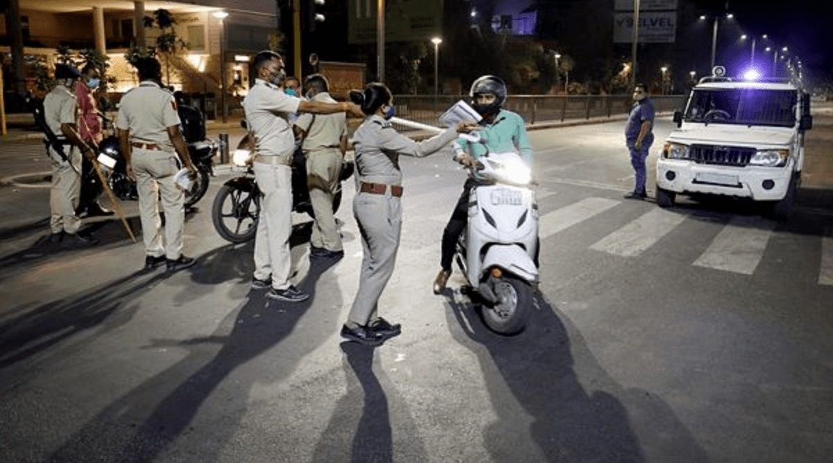 Police personnel stop people during a night curfew, amidst spike in coronavirus cases, in Ahmedabad. (PTI Photo)
