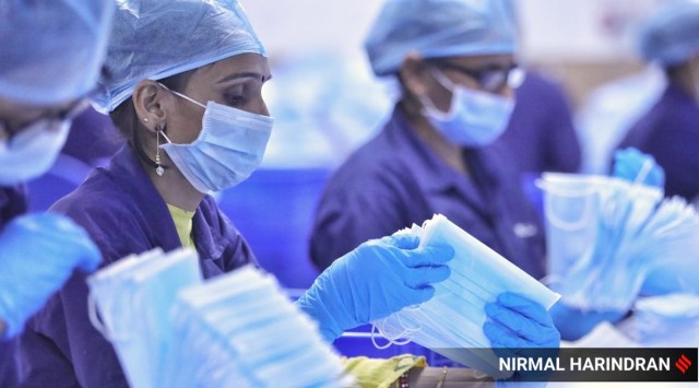 Workers make surgical masks at a production unit in Ahmedabad.