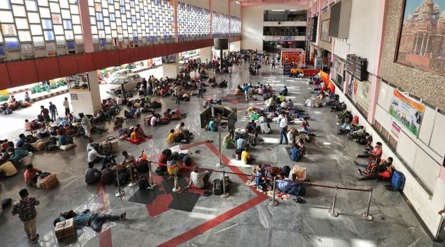 Migrant workers waiting for outbound trains, at Kalupur station in Ahmedabad on Sunday. (Express photo by Nirmal Harindran)