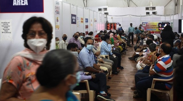 People queue up at a vaccination centre in Mumbai. (Express photo: Pradip Das)