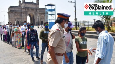 People queue up outside the Gateway of India complex in Mumbai on Sunday to get themselves tested for Covid-19. (PTI)