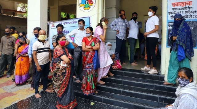 People queue up outside Kalavati Mavale Hospital in Pune on Saturday to get their Covid-19 vaccine shots. (Express Photo: Pavan Khengre)