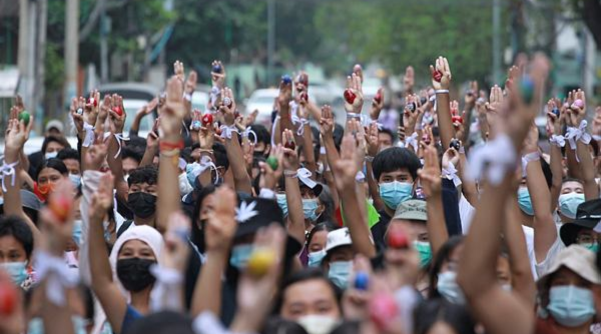Anti-coup protesters raise decorated Easter eggs along with the three-fingered symbols of resistance during a protest against the military coup on Easter Sunday, April 4, 2021, in Yangon, Myanmar. (AP Photo)