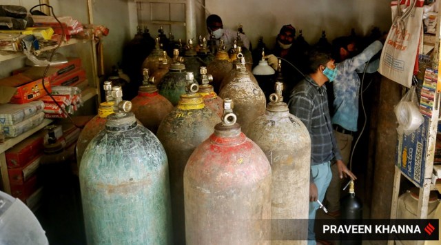 People queue up at a shop to refill their oxygen cylinders in New Delhi. 