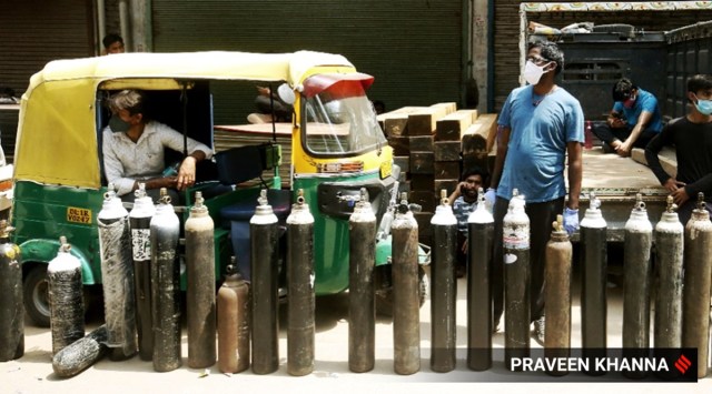 Relatives of Covid-19 patients queue up to refill oxygen cylinders. (Express Photo: Praveen Khanna)