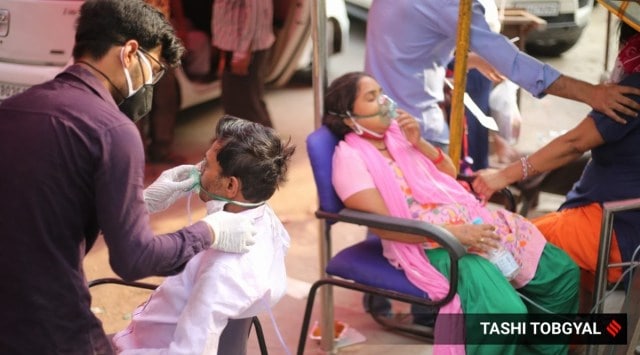 Covid-19 patients at an 'oxygen langer' in a gurudwara in New Delhi on Friday. (Express Photo: Tashi Tobgyal)