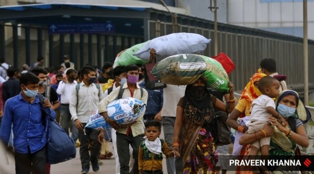 Migrant labourers at Anand Vihar bus terminal in New Delhi. (Express Photo by Praveen Khanna)