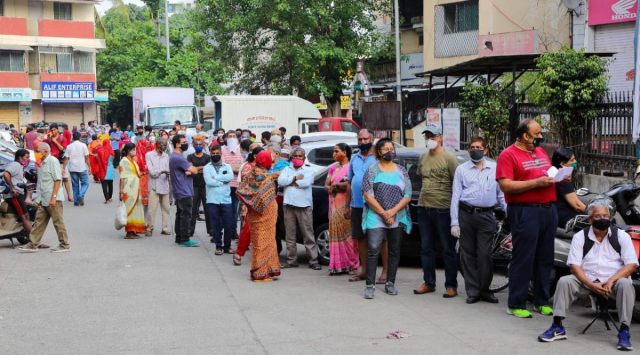 People gathered in huge numbers from early morning to take tokens for covid vaccination at Chhatrapati Shahu Maharaj Hospital Wanawadi, Pune, on Thursday. 
(Express photo by Ashish Kale)