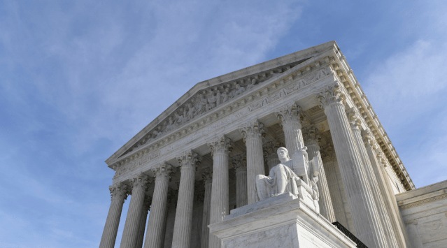 A view of the Supreme Court in Washington. The Supreme Court appears ready to prevent thousands of people living in the U.S. for humanitarian reasons from applying to become permanent residents. The justices seemed favorable to arguments made by the Biden administration on April 19, 2021, that federal immigration law prohibits people who entered the country illegally and now have Temporary Protected Status from seeking “green cards” to remain in the country permanently. (AP Photo/Susan Walsh, File)