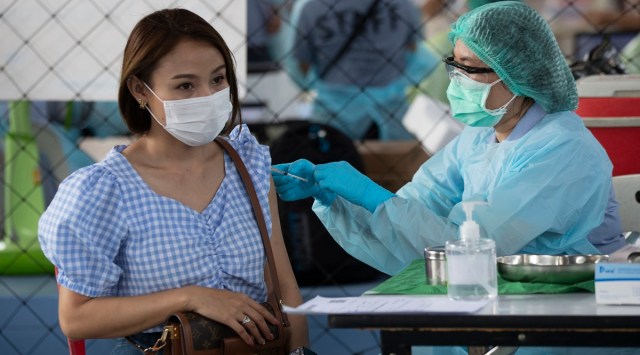 A health worker administers a dose of the Covid-19 vaccine to a woman in Bangkok. (AP)