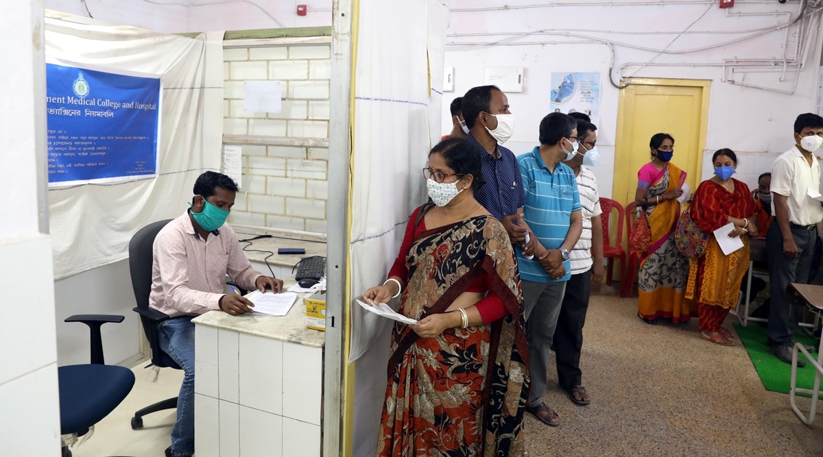 People queue up at a healthcare centre in Raiganj, West Bengal, to get vaccinated. (Express Photo: Partha Paul) 