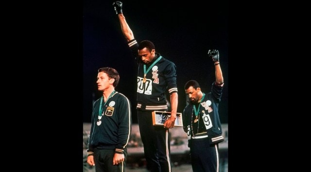 In this Oct. 16, 1968 file photo, U.S. athletes Tommie Smith, center, and John Carlos raise their gloved fists after Smith received the gold and Carlos the bronze for the 200 meter run at the Summer Olympic Games in Mexico City. (AP Photo)
