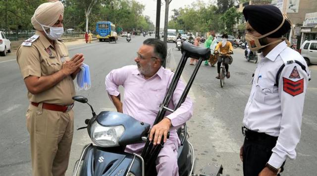 A traffic policeman urges a biker to wear face mask, amid rising Covid -19 cases across the country, in Bathinda, Friday, April 16, 2021. (PTI Photo)