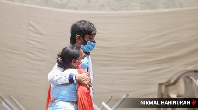 Relatives mourn the death of a person died due to Corona virus disease outside the dead body department of Civil hospital in Asarwa, Ahmedabad. 