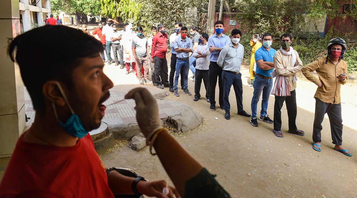 A medic collects swab samples for Covid-19 tests at Civil Hospital in Gurugram. (PTI Photo)