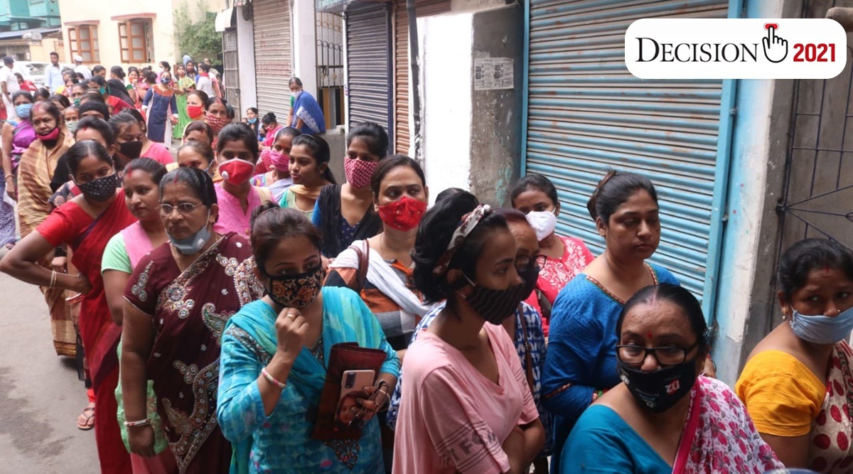 Voters queue up in front of a booth at in Kolkata on Saturday (Express photo by Shashi Ghosh)