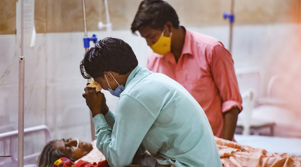 A Family member gets emotional as he sits next to a Covid-19 patient inside the Covid ward at MMG hospital, amid the rise in Covid-19 patients across the country, in Ghaziabad, Sunday, April 18, 2021. (PTI photo)