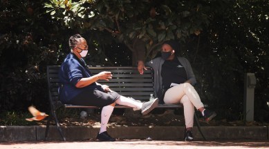 People wear face masks at a park in Charlotte, N.C. on Tuesday, April 27, 2021. (Travis Dove/The New York Times)