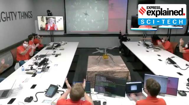Team at NASA's JPL reacts after Ingenuity (on screen) makes its first flight on Mars on Monday. (Source: NASA video grab via Reuters)