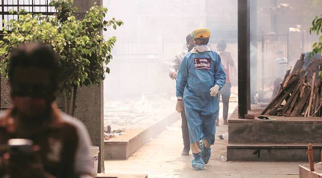 Jitender Singh Shunty (in the PPE kit). (Express Photo by Amit Mehra)