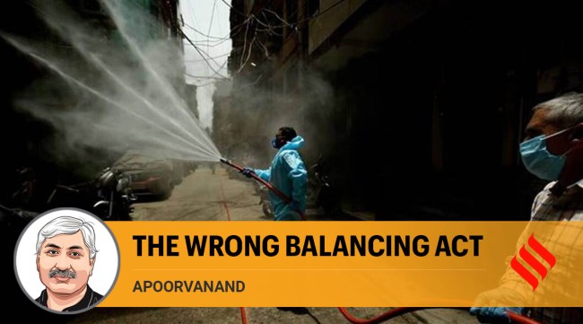 A health worker sanitises an area in New Delhi amid the Covid-19 pandemic (Express Photo: Praveen Khanna)