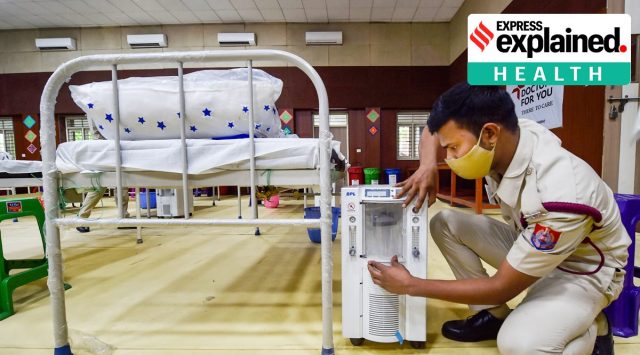 A volunteer prepares beds with oxygen concentrators at a Covid Care Centre inside Sarvodaya Bal Vidyalaya, as coronavirus cases surge in New Delhi, Tuesday, April 20, 2021. (PTI Photo/Manvender Vashist)