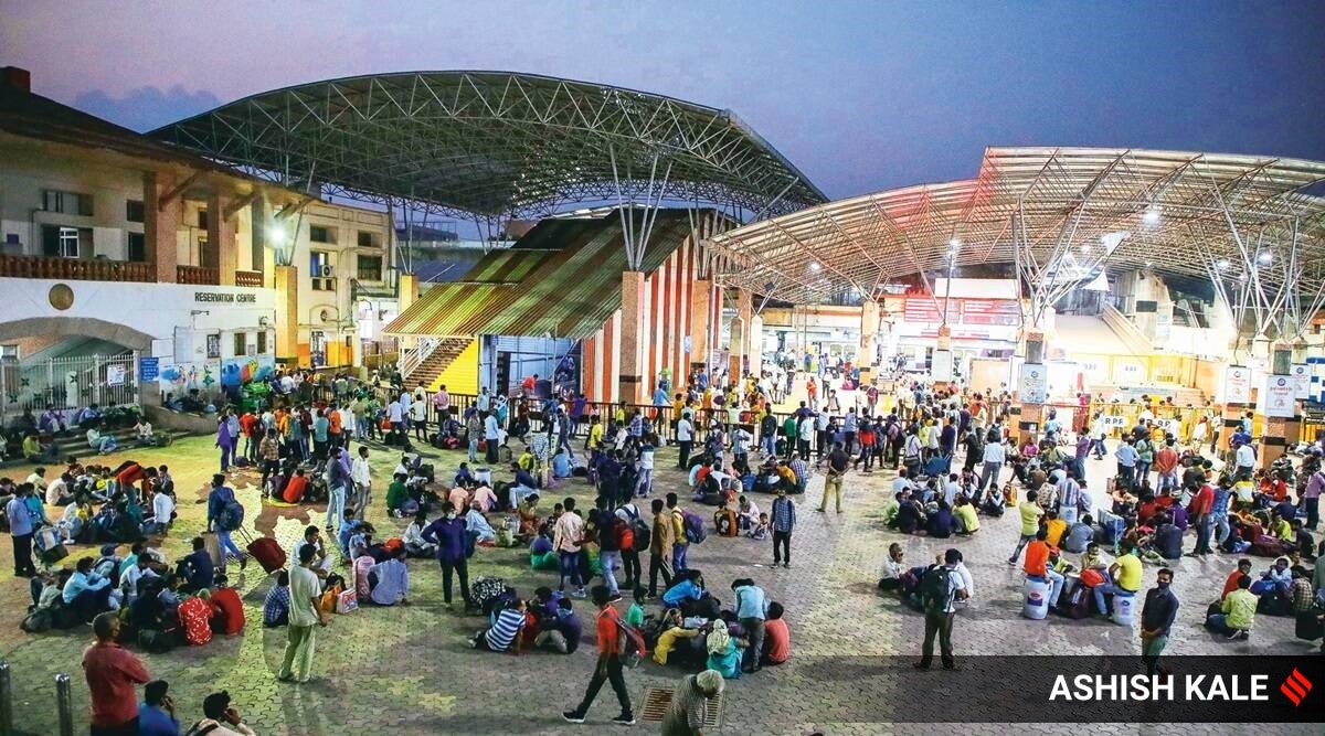 At Pune railway station on Sunday evening. Amid rising Covid cases and fears of another lockdown in Maharashtra, migrants have been gathering at railway stations in an attempt to return home. (Express Photo: Ashish Kale)