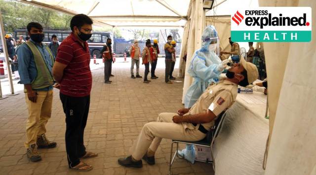 A Delhi Police personnel gets tested for Covid-19 in New Delhi. (Express Photo: Praveen Khanna)