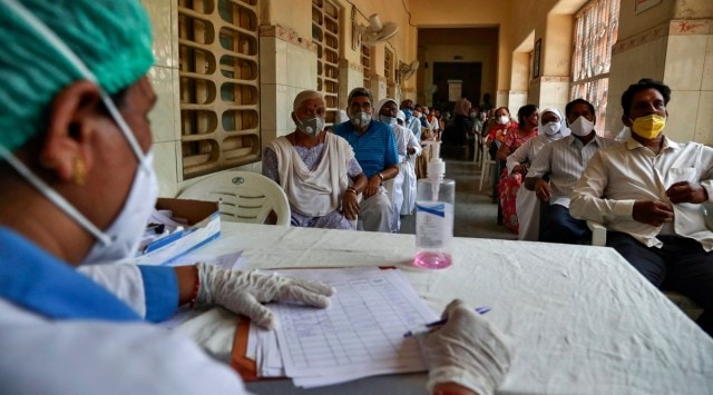 People wait for their turn to be administered the Covid-19 vaccine at a government hospital in Hyderabad. (AP)