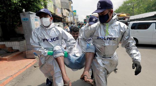 Police officers detain a person for not wearing a mask, breaking COVID-19 rules and regulations, near a main market in Colombo, Sri Lanka May 7, 2021. (Source: Reuters)