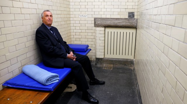 Philip Gough, a former police inspector who worked at the police station between 1989 and 1992, poses for a photograph in a cell at the Bow Street Police Museum. (Photo: Reuters)