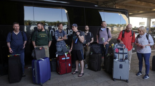 Tourists wait next to a bus outside Ben Gurion International Airport after entering Israel by plane, as coronavirus disease (COVID-19) restrictions ease, in Lod, near Tel Aviv. (Photo: Reuters)