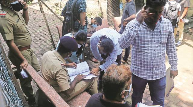 A police officer verifies the family members of the deceased outside the mortuary at 
JJ Hospital in Mumbai. (Express Photo by Ganesh Shirsekar)