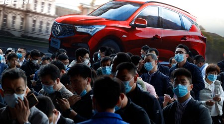 In this April 21, 2021, file photo, visitors attend the Shanghai Auto Show in Shanghai. The United Nations has responded to the rebounding Chinese and U.S. economies by revising its global economic forecast upward to 5.4% for 2021. But it warned that surging COVID-19 cases and inadequate availability of vaccines in many countries threaten a broad-based recovery. (AP Photo)