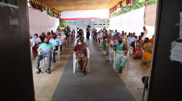 Senior citizens wait inside a vaccination centre in Pune. (Express Photo By Pavan Khengre)