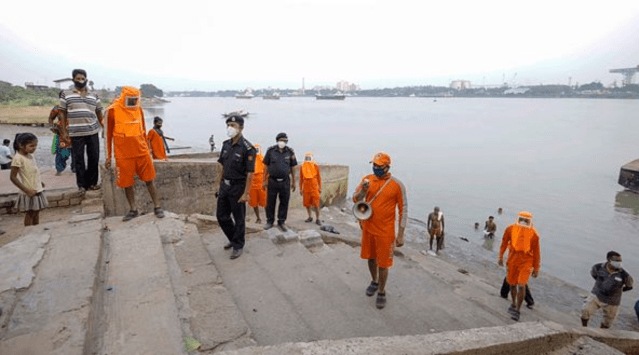 NDRF team announce cyclone related alerts, ahead of landfall of Cyclone 'Yaas', in Howrah district, Sunday, May 23, 2021. (PTI Photo)