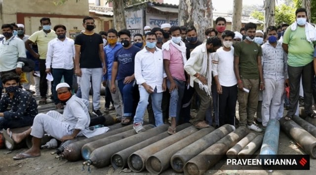 Relatives of Covid-19 patients queue up to refill oxygen cylinders in New Delhi. (Express Photo: Praveen Khanna)