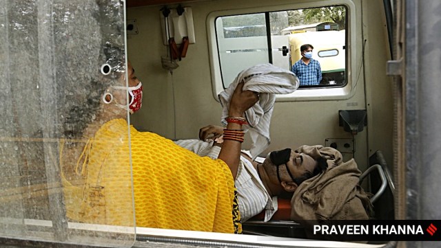A Covid patient waits in an ambulance to be admitted to LNJP hospital, outside LNJP Hospital in New Delhi on Tuesday. (Express photo by Praveen Khanna)