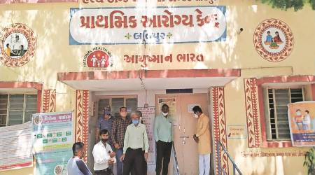 Paresh Dhanani and other Congress leaders outside the PHC at Latipur village in Jamnagar on Friday. (Express)